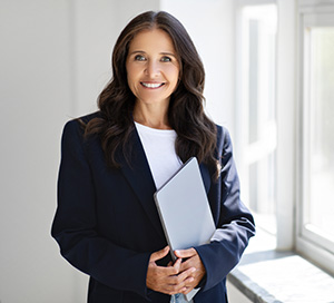 Ortley Beach real estate agent in a dark suit holding a file
